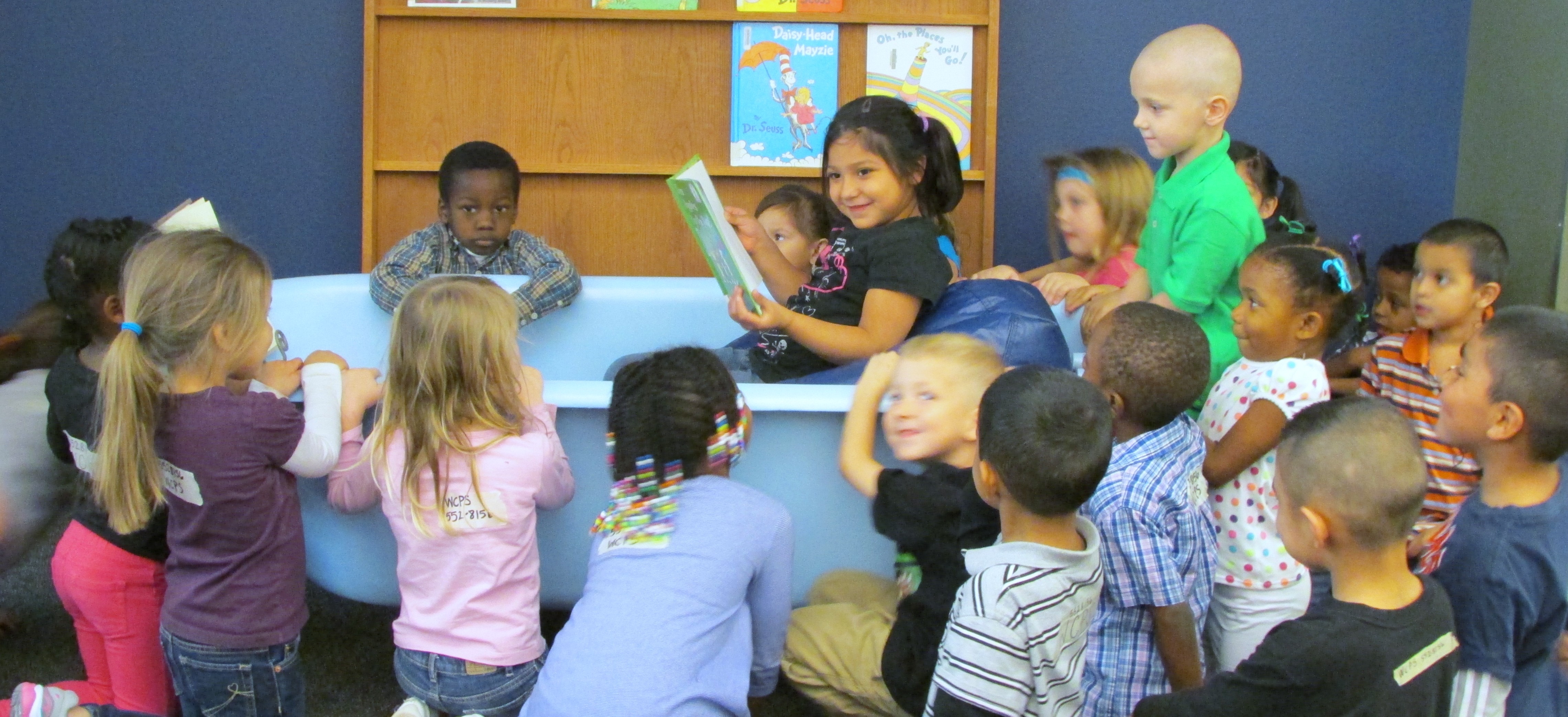 Wilbarger County Preschool student reading to her fellow classmates. May be a young aspiring librarian!